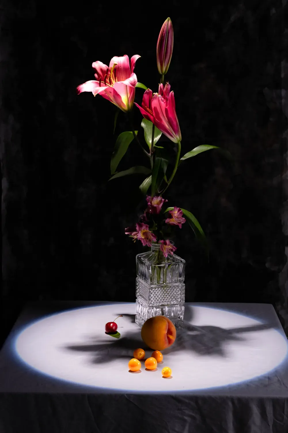 Arreglo de flores secas y fruta bajo luz cálida